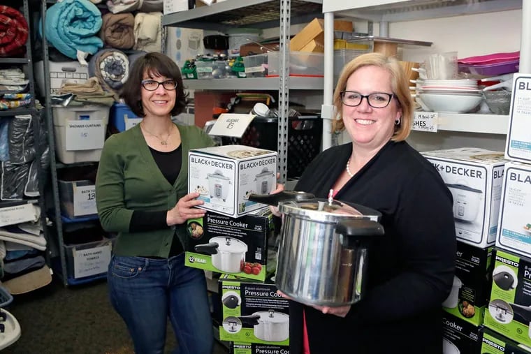 Elizabeth Zack (left) and Juliane Ramic in the Nationalities Service Center closet of household goods.