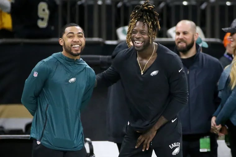 Eagles running backs Donnel Pumphrey (left) and Jay Ajayi on the sideline before the team's divisional round playoff game against the New Orleans Saints.