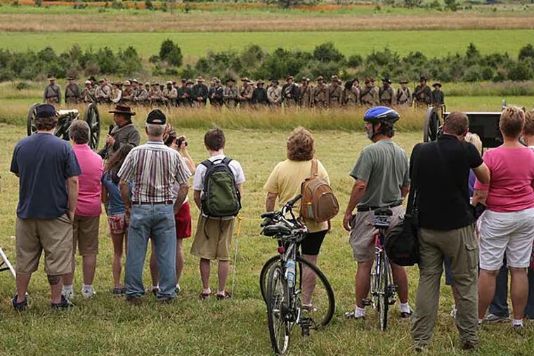 Tourists watch a re-enactment of the Battle of Gettysburg, fought 150 years ago this week.