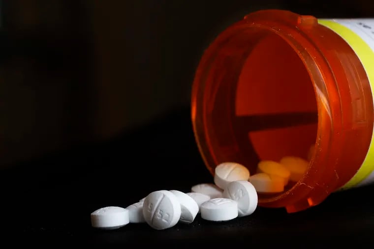 FILE - This photo shows an arrangement of Oxycodone pills in New York on  Aug. 29, 2018. The Oklahoma Supreme Court has overturned a $465 million opioid ruling against drugmaker Johnson & Johnson, finding that a lower court wrongly interpreted the state’s public nuisance law. The court ruled in a 5-1 decision Tuesday, Nov. 9, 2021, that the district court in 2019 was wrong to find that New Jersey-based J&J and its Belgium-based subsidiary Janssen Pharmaceuticals violated the state’s public nuisance statute. (AP Photo/Mark Lennihan, File)
