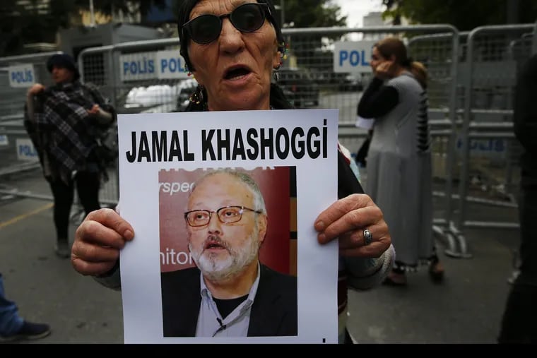 An activist, member of the Human Rights Association Istanbul branch, holds a poster with a photo of missing Saudi journalist Jamal Khashoggi, during a protest in his support near the Saudi Arabia consulate in Istanbul, Tuesday, Oct. 9, 2018. Turkey said Tuesday it will search the Saudi Consulate in Istanbul as part of an investigation into the disappearance of a missing Saudi contributor to The Washington Post, a week after he vanished during a visit there. (AP Photo/Lefteris Pitarakis)