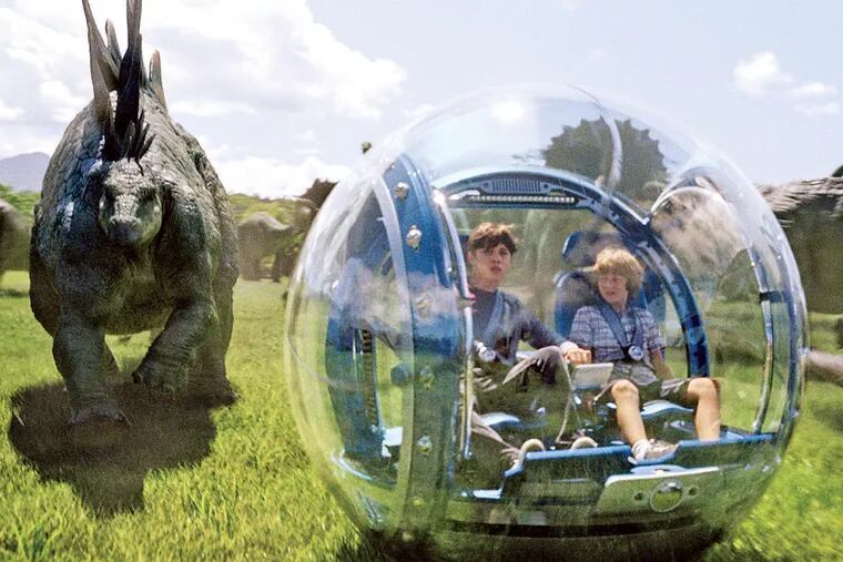 Characters roam among the dinosaurs in “Jurassic World.” The film boosted Comcast’s third-quarter earnings.