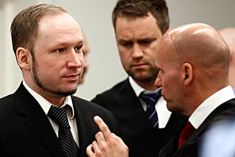 Anders Behring Breivik (left) confers with his attorneys, Geir Lippestad (right) and Odd Ivar Groen. Prosecutors grilled him Wednesday, suggesting that the &quot;Knights Templar&quot; group he claimed to belong to was fictitious. LISE ASERUD / Associated Press, Pool