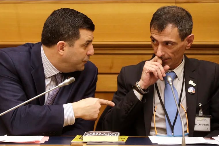 State Rep. Mark Rozzi (D., Berks), left, speaks to sex abuse survivor Francesco Zanardi, right, during a news conference in Rome earlier this year. That trip, Rozzi said, changed the way he thinks about statute of limitations legislation and his own experiences as a sex abuse survivor.
