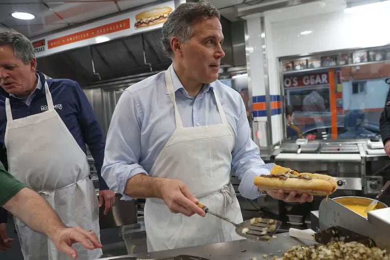 GOP Senate candidate Dave McCormick learns how to make cheesesteaks at Geno’s Steaks in Philadelphia during a campaign stop on Wednesday, April 3, 2024.