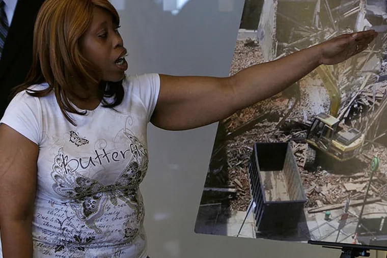 Felicia Hill points to a photo of the Salvation Army building, when telling her story of how she escapedfrom Wednesday's building collapse. Hill was working in the Salvation Army thirft shop at the time of the collapse, and was pulled from the building by a bystander. June 10, 2013.  (LUKE RAFFERTY/Staff Photographer)