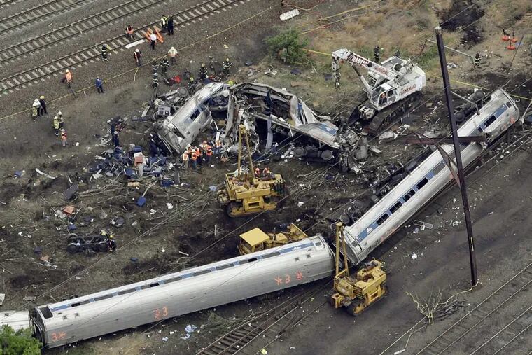 Emergency personnel work at the scene of the derailment in Philadelphia of an Amtrak train headed to New York in May 2015.