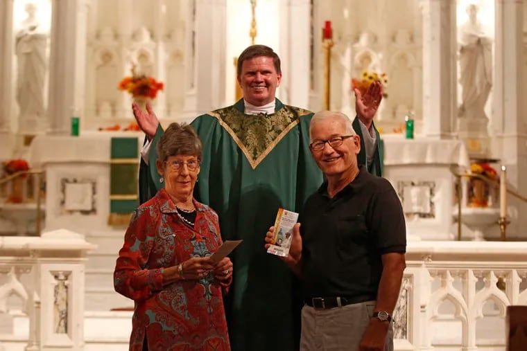 John and Kathleen McCarthy are joined by the Rev. J. Thomas Heron at St. Matthew Church in Conshohocken. They were selected to meet the pope based on their commitment to the church and the sacrament of marriage. (MICHAEL BRYANT/Staff Photographer)