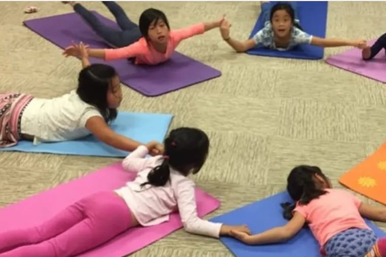 A kids yoga class at Downward Dog Dance, Yoga & Wellness in Richmond, Virginia.