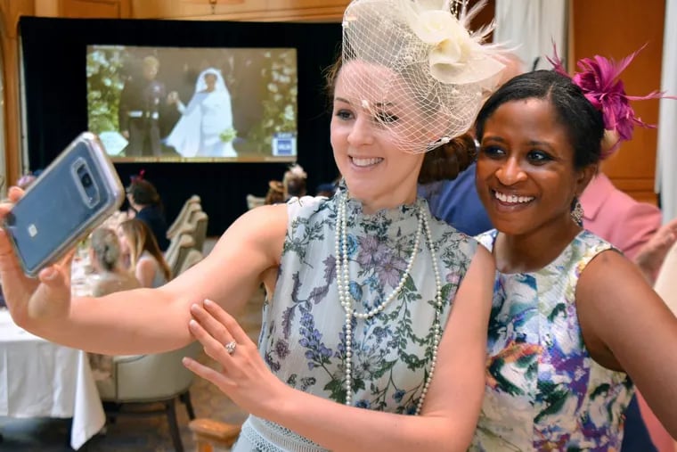 Friends Katherine Twell, center, and Jessica James pause for a selfie as finely attired attendees gathered in the Lacroix Restaurant at The Rittenhouse enjoy viewing the royal wedding of Prince Harry and Meghan Markle on Saturday morning, May 19, 2018.