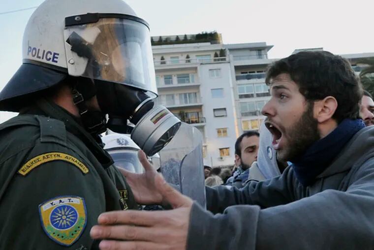 Protesters quarrel with police near Parliament in Athens. Unrest comes amid economic fears.