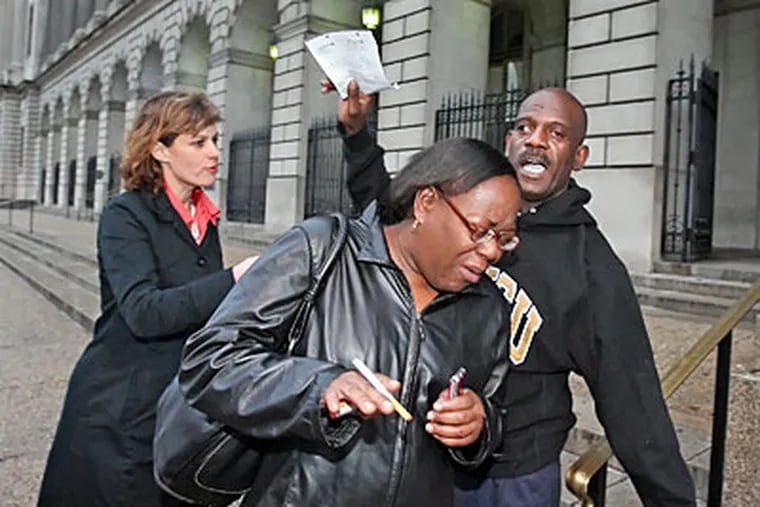 A parent of one of the charged youths leaves Family Court after the hearing. (Steven M. Falk / Staff Photographer )
