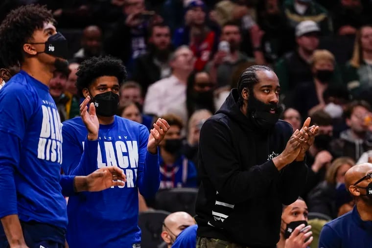 James Harden claps from the bench during the first half of an NBA basketball game against the Milwaukee Bucks Thursday, Feb. 17, 2022, in Milwaukee. (AP Photo/Morry Gash)