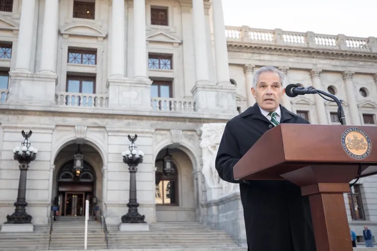 Philadelphia District Attorney Larry Krasner speaks at a news conference on the Capitol Steps in Harrisburg.