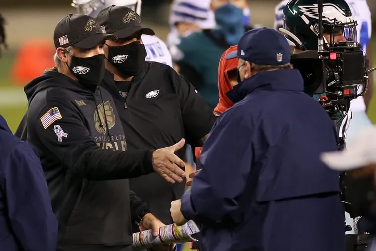 Eagles head coach Doug Pederson, left, shakes hands with Dallas Cowboys head coach Mike McCarthy after the game.