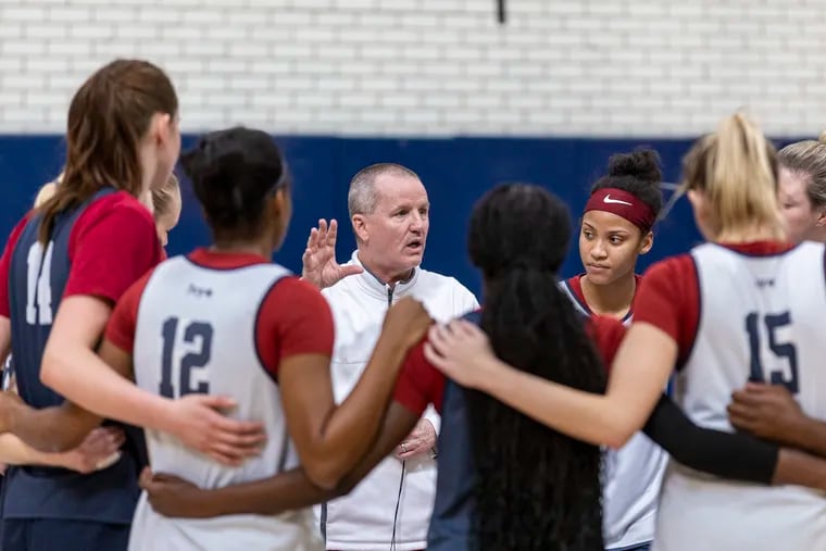 Penn coach Mike McLaughlin talks with his team at the end of practice inside Rockwell Gymnasium earlier this week.