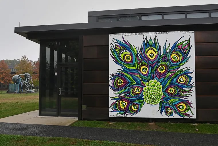 Laura Erickson's painting of peacock feathers adds a dash of color to the Copeland Sculpture Garden at the Delaware Art Museum in Wilmington. Over the past year, U.S. paint companies have been in chaos getting certain colors.