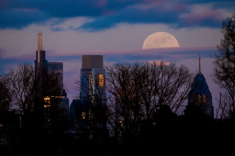 A supermoon preludes a total lunar eclipse in Philadelphia on Sunday evening. 
The moon, Earth and sun lined up for the only total lunar eclipse this year and next. At the same time, the moon was ever so closer to Earth and appeared slightly bigger and brighter than usual — a supermoon.
