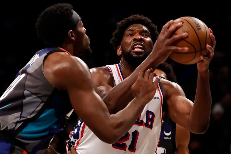 Philadelphia 76ers center Joel Embiid drives to the basket past Brooklyn Nets center Day'Ron Sharpe during the first half Sunday's win.