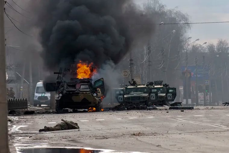 A Russian armored personnel carrier burning amid damaged and abandoned light utility vehicles after fighting in Kharkiv, Ukraine, on Sunday.