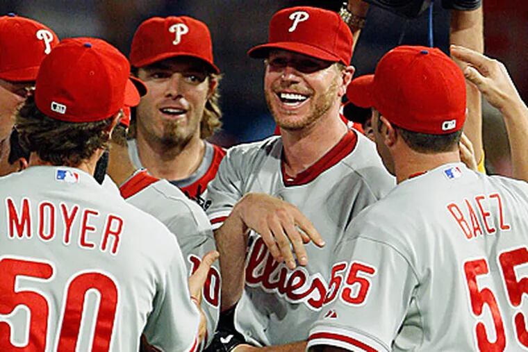 Roy Halladay is mobbed by teammates after throwing a perfect game against the Florida Marlins. (AP Photo/Wilfredo Lee)