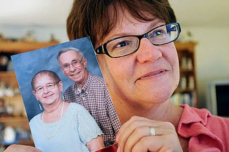 Beth Ricci with a picture of her parents, Don and Kay Clark. "They taught us about what love really is," she said. (Sharon Gekoski-Kimmel / Staff Photographer)