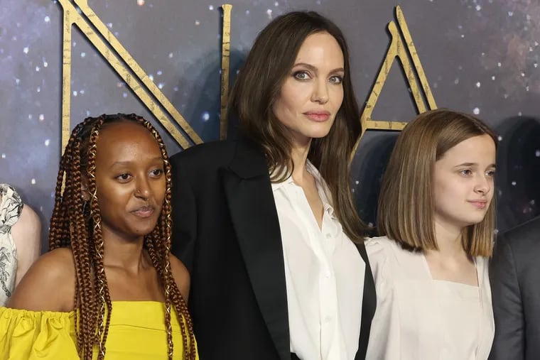 From left, Zahara Jolie-Pitt, Angelina Jolie and Vivienne Jolie-Pitt attend the "Eternals" United Kingdom premiere at the BFI IMAX Waterloo on Oct. 27, 2021 in London.