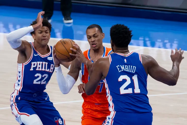 Oklahoma City Thunder's Darius Bazley (7) is surrounded by the Sixers' Joel Embiid and Matisse Thybulle in the first half on  Saturday, April 10, 2021, in Oklahoma City.