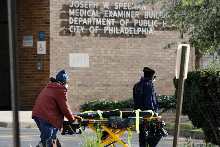 An empty stretcher is moved at the Joseph W. Spellman Medical Examiner Building in University City.