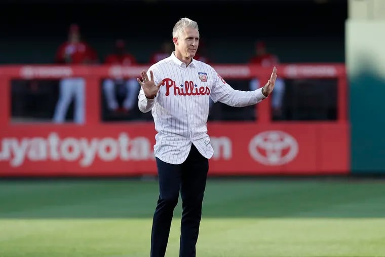 Former Phillies second baseman Chase Utley raised his arms at second base during his retirement ceremony at Citizens Bank Park in 2019.