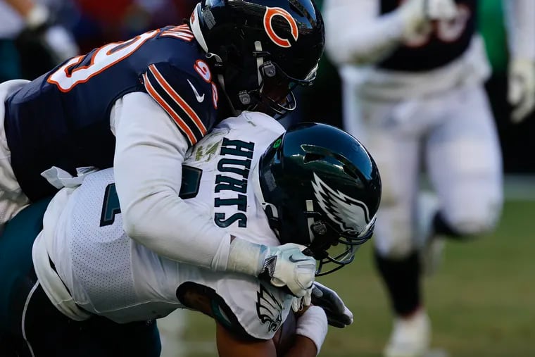 Eagles quarterback Jalen Hurts gets taken down by Chicago Bears linebacker Trevis Gipson on Sunday, December 18, 2022 in Chicago.