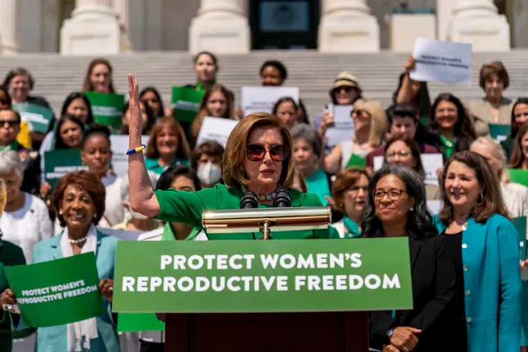 House Speaker Nancy Pelosi of Calif., accompanied by female House Democrats, speaks at an event ahead of a House vote on the Women's Health Protection Act and the Ensuring Women's Right to Reproductive Freedom Act at the Capitol in Washington, Friday, July 15, 2022.