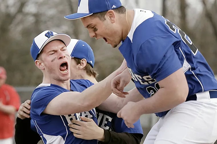 Williamstown's # 22 Paul Gerstle, # 42 Zach Dougherty and # 20 Paul Flagg celebrate after the final out of the Cherry Hill East at Williamstown H.S. boys baseball game on April 2, 2015. Gerstle had been called upon to pitch late in the 7th inning and Williamstown won the game 9-8. (Elizabeth Robertson/Staff Photographer)