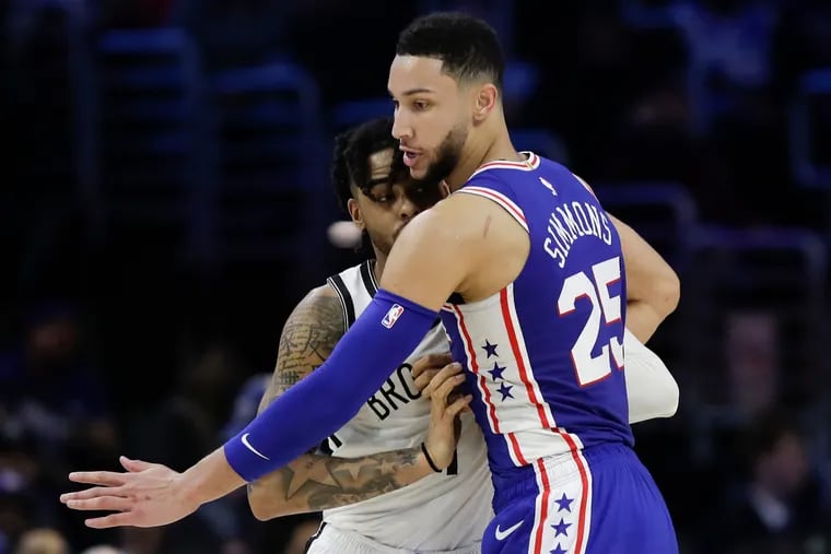 Ben Simmons defends Nets guard D'Angelo Russell during the third quarter.