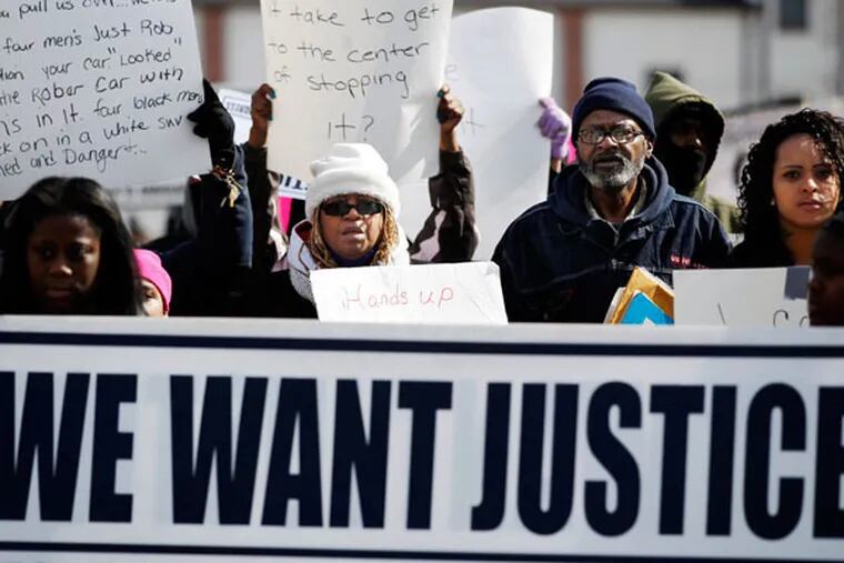 Shelia Reid, center with hat, mother of Jerame Reid, walks with others as people hold signs and shout as they march Saturday, Feb. 28, 2015, in protest of the fatal police shooting of Jerame in Bridgeton, N.J. (AP Photo/Mel Evans)