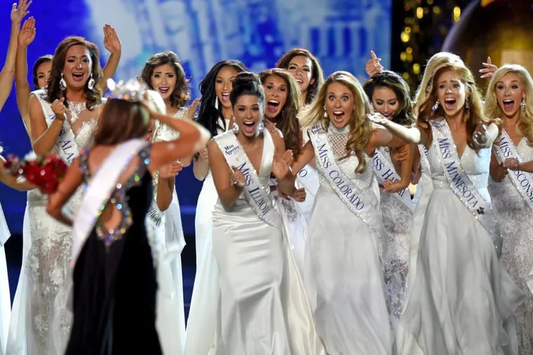 Her fellow contestants cheer as the newly crowned Miss America 2018, Miss North Dakota Cara Mundin (back to camera) rejoins them after taking her winner's walk on stage at the 97th Miss America Pageant in Atlantic City September 10, 2017. TOM GRALISH / Staff Photographer YEAREND2017-ee
