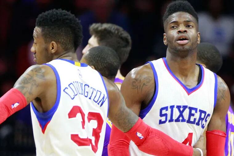 Nerlens Noel, right, of the Sixers reacts after missing 2 free throws in overtime against the Lakers on March 30, 2015, at the Wells Fargo Center. Robert Covington is left.
