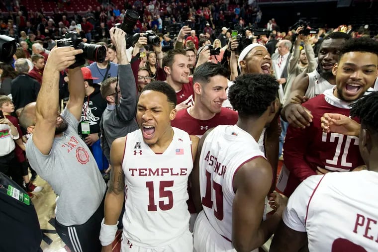 Nate Pierre-Louis celebrates with his teammates and Temple fans after the Owls beat UCF on Saturday.