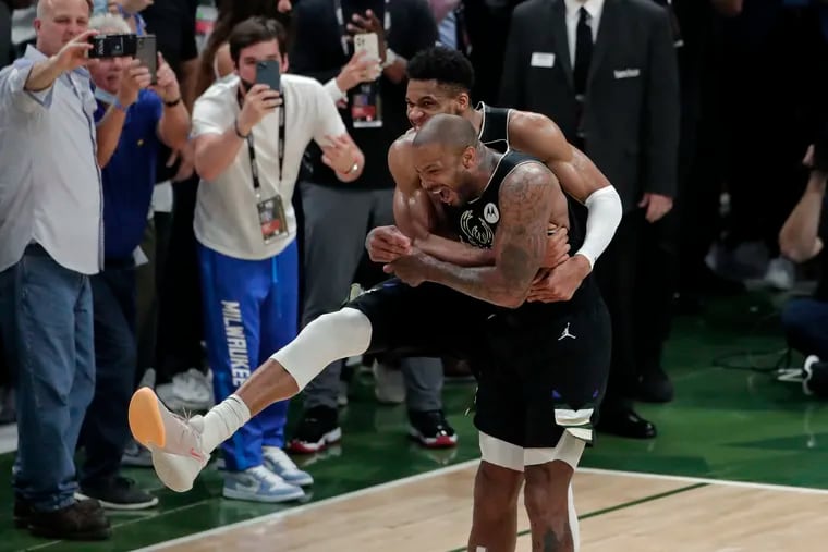 Milwaukee forward Giannis Antetokounmpo hugged forward P.J. Tucker after the Bucks defeated the Phoenix Suns in Game 6 of the NBA Finals to clinch the championship.