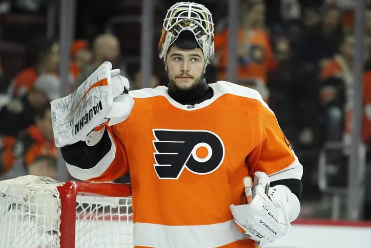 Flyers goalie Alex Lyon pauses during a break in the action during the first period of an NHL hockey game against the Montreal Canadiens Tuesday, Feb. 20, 2018 in Philadelphia. The Flyers won 3-2.
