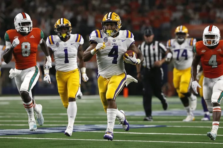 LSU running back Nick Brossette (4) runs for a touchdown as Miami defensive backs DJ Ivey (8) and Jaquan Johnson (4) give chase during the first half of an NCAA college football game Sunday, Sept. 2, 2018, in Arlington, Texas. (AP Photo/Ron Jenkins)