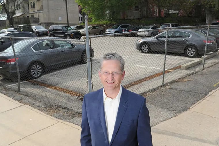 David Yeager, founder and president of Radnor Property Group LLC, stands at the corner of Race and 32nd Streets where his company will be building a 16-story apartment - retail building in conjunction with Drexel University. (CLEM MURRAY/Staff Photographer)