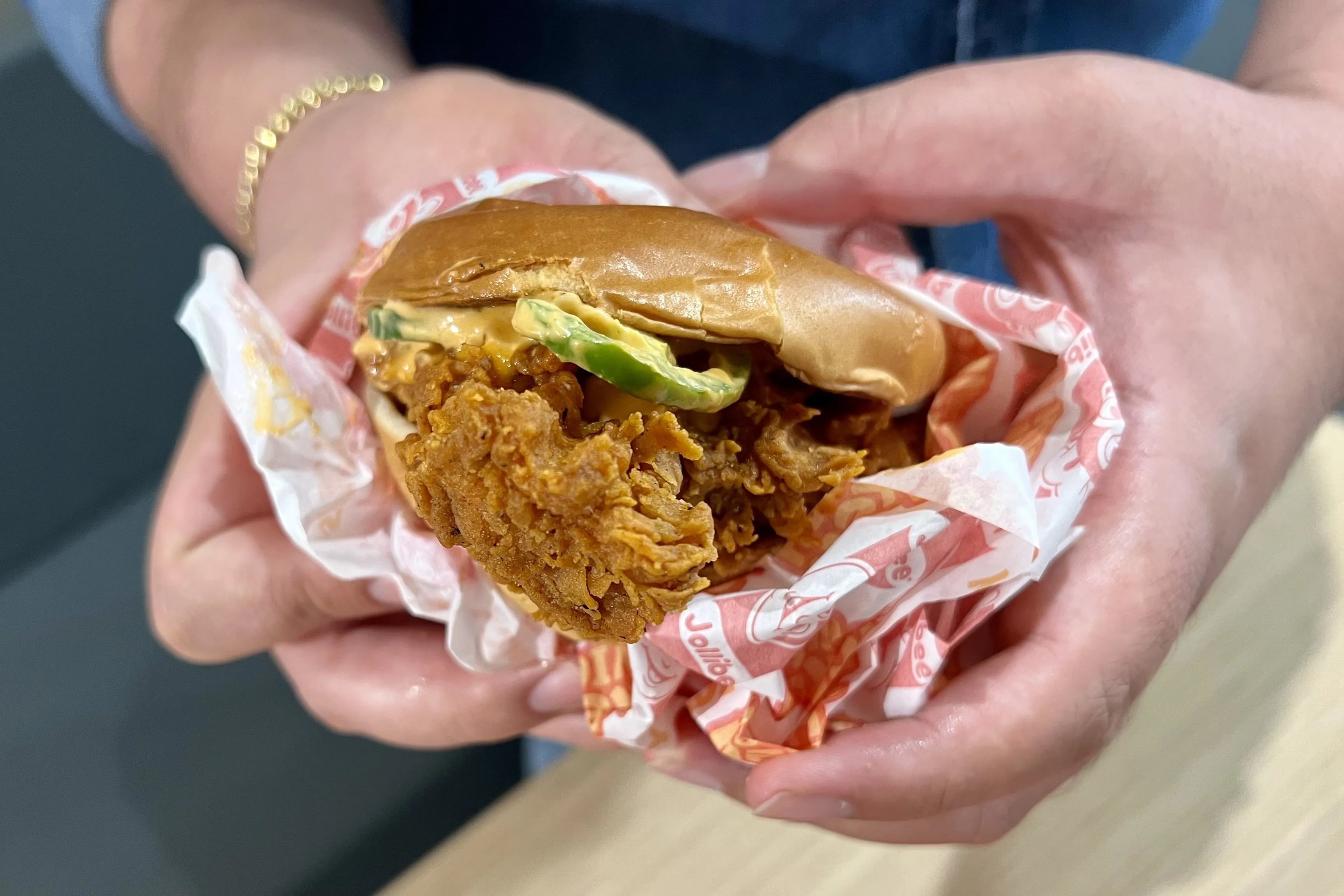 The boneless chicken sandwich from Jollibee gets hot peppers and umami mayo at the location at 7340 Bustleton Ave.