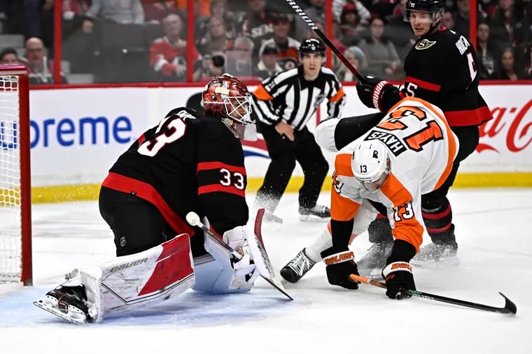 Senators goaltender Cam Talbot (33) watches the rebound as defenseman Nick Holden (5) forces Flyers center Kevin Hayes (13) out of position during the first period on Nov. 5 in Ottawa, Ontario.