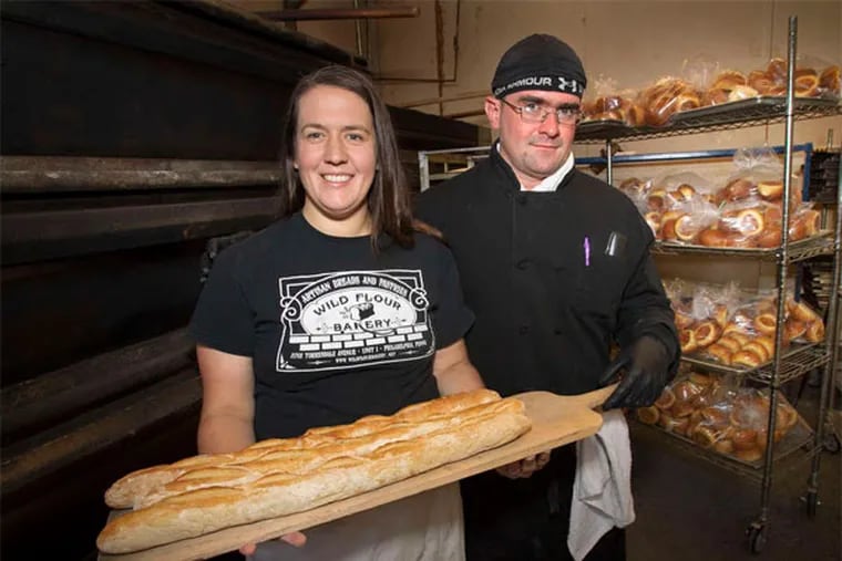 Wild Flour Bakery owners Laura and Nishon Yaghoobian show off their baguettes. Their Holmesburg operation does wholesale baking for restaurants and, in warm months, sells at farmers' markets. (Alejandro A. Alvarez / Staff Photographer)