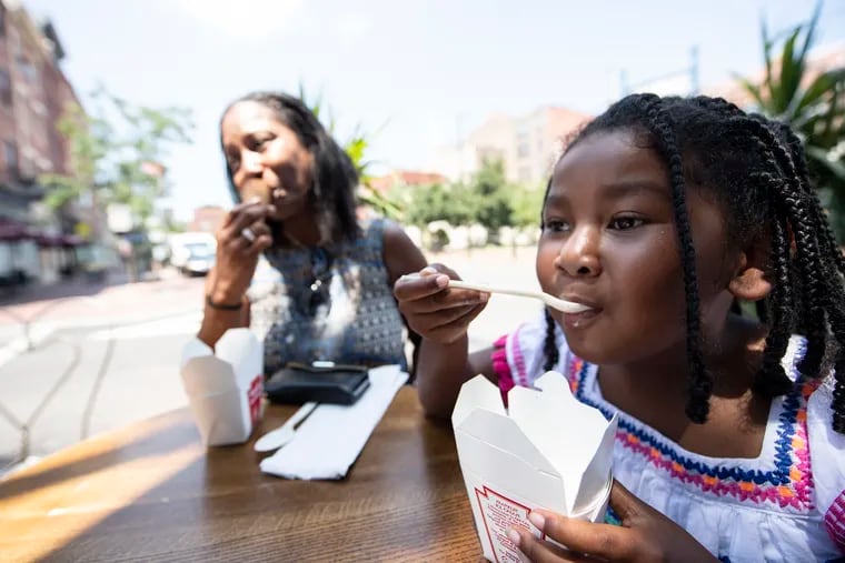 Crystal Goodwyn and her daughter Gabbi, enjoy some morning ice cream at the Franklin Fountain on Market Street.