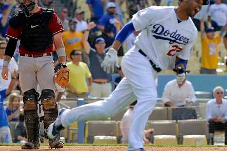The Dodgers' Matt Kemp exults as Diamondbacks catcher Chris Snyder walks off the field after L.A.'s 1-0 win in 14 innings.