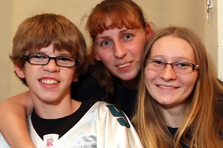 Thomas Ristine and his sister Sara join their mom, Mabel, wearing post-op glasses. (Steven M. Falk / Staff Photographer)