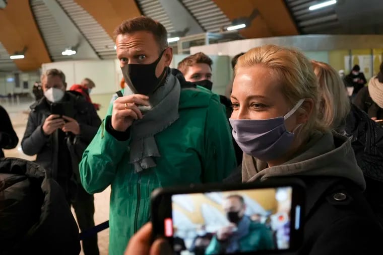 Alexei Navalny and his wife Yuliastand in line at the passport control after arriving at Sheremetyevo airport, outside Moscow, Russia, Sunday, Jan. 17, 2021. Russia's prison service says opposition leader Alexei Navalny has been detained at a Moscow airport after returning from Germany.