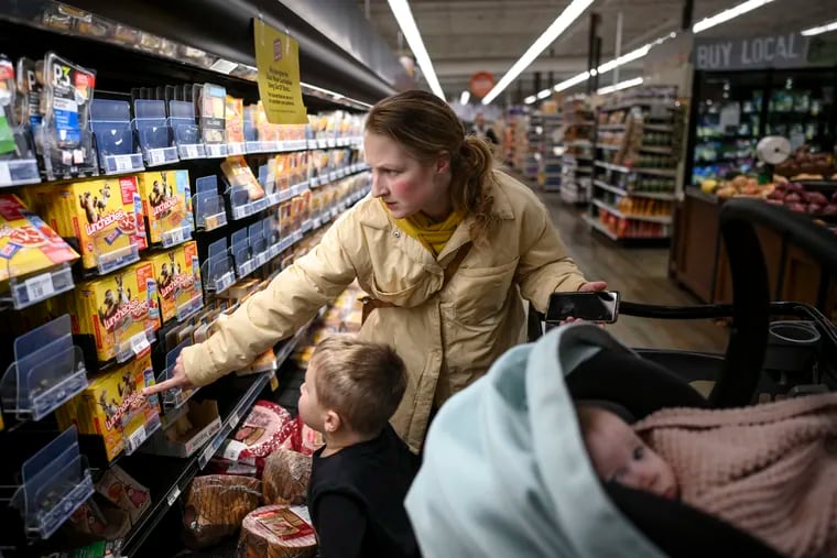 Lynette Muonio, of Howard Lake, Minnesota, shops for groceries with her children at Coborn's in Delano, Minnesota. She was asking Shi whether he wanted cheese or pepperoni Lunchables, the only two options he'd be interested in since most of the Lunchables were out of stock due to supply issues.